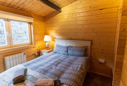 a bedroom with a bed in a wooden cabin at Wildwood Haven - Killorglin in Killorglin