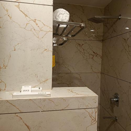 a bathroom with a shower with a mirror at Leaf 9 Imperial, Subhash Nagar, Pacific Mall in New Delhi