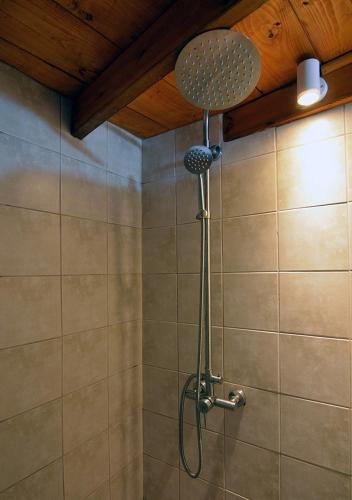 a shower with a shower head in a bathroom at Salty Splash in Klima