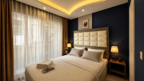 a bedroom with a large bed and a window at Teker Suite Hotel in Mersin