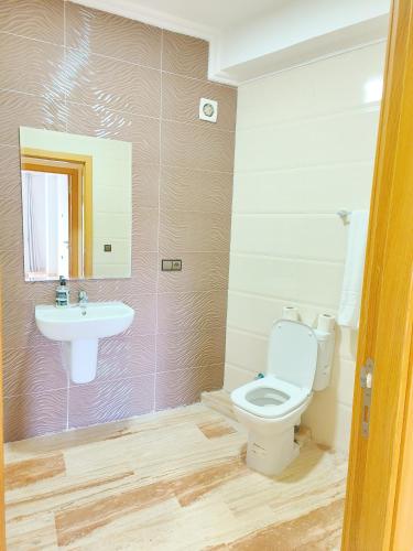 a bathroom with a toilet and a sink at Golden Holiday Family Only in Tangier