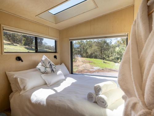 a bedroom in a caravan with a bed and a window at Crown Equine Retreat in North Dandalup