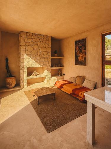 a living room with a bed and a fireplace at Surfiscamp Dakhla in Dakhla