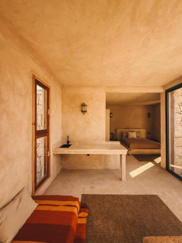 a living room with a table and a couch at Surfiscamp Dakhla in Dakhla