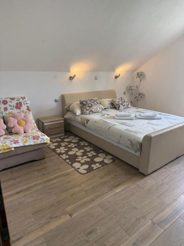 a bedroom with two beds in a room with a staircase at Apartment Slap in Rakovica
