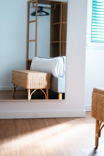 a living room with a chair and a mirror at Casa do Mar in Ribeira Grande