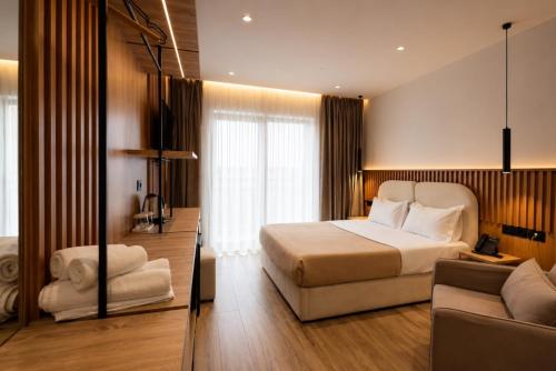 a hotel room with a bed and a couch at Albatros Beach & Resort in Rrogozhinë