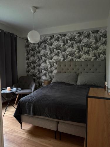 a bedroom with a large bed with a large headboard at LIS Apartment in Naantali