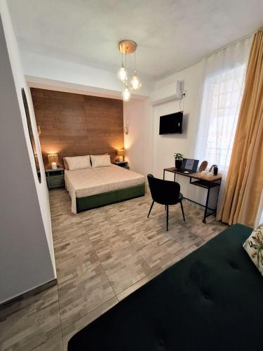a bedroom with a bed and a desk with a laptop at Solmara in Lozenets