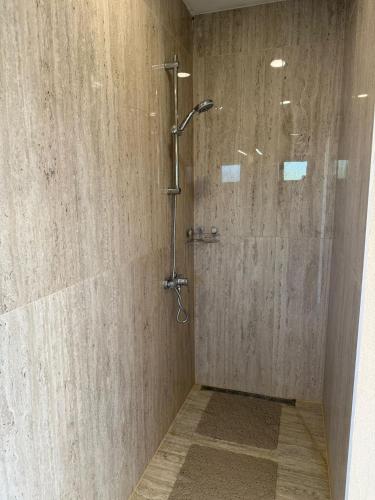 a shower with a glass door in a bathroom at House on the river in Karlovac