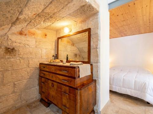 a bathroom with a sink and a mirror in a room at Casa Tino - Retreat by the Sea and History in Polignano a Mare
