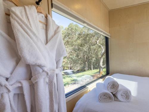 a bedroom with a window with towels on a bed at Crown Equine Retreat in North Dandalup