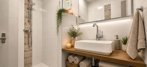 a white bathroom with a sink and a shower at Residence Arinella in Farinole