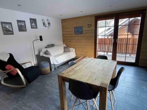 a room with a table and chairs and a bed at Sole Mountain apartement in Zermatt