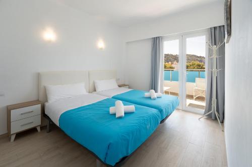 a bedroom with a large bed with two white crosses on it at DOLS MAR APARTMENTS in Camp de Mar
