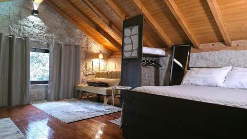 a bedroom with a bed and a chair in a room at Moose House EV Charging Pool Gated Community in Loivos