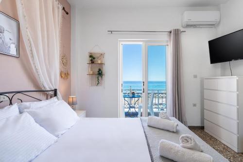 a bedroom with a bed with a view of the ocean at Anthia studio in Koutsourás