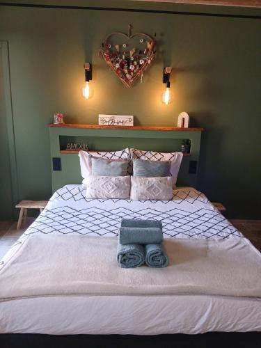 a bedroom with a bed with a towel on it at instant à deux in Précigné