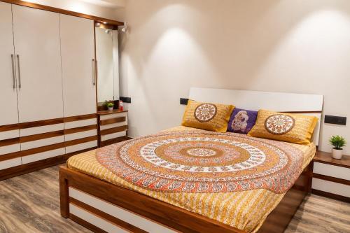 a bedroom with a large bed and a white cabinet at Vista Royal 2BHK With Private Pool in Igatpuri