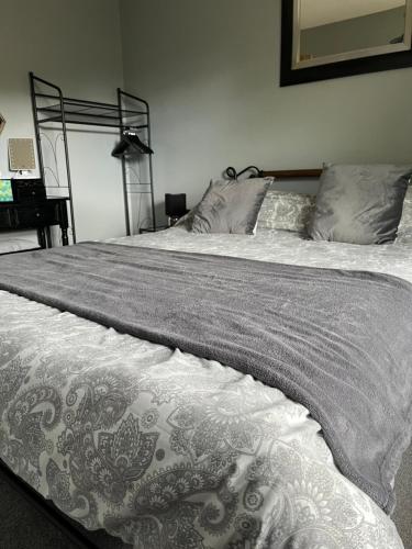 a bedroom with a large bed with a gray blanket at Apartment 288 in Lower Swanwick