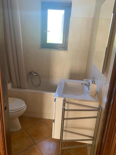 a bathroom with a sink and a toilet and a window at Roma country resort in Rome