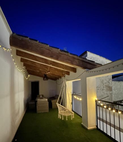 a porch with a hammock on a house at night at Casa Vicen in Bolbaite