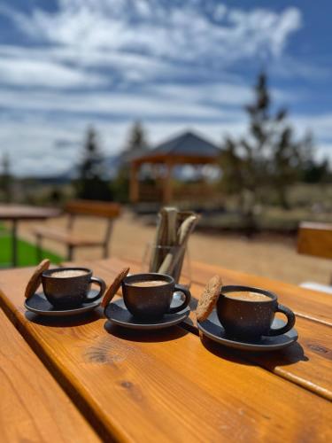 two cups of coffee sitting on a wooden table at 4 BEARs in Kovačka Dolina
