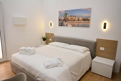 a bedroom with a bed with towels on it at Adriatic Breeze Rooms in Mola di Bari