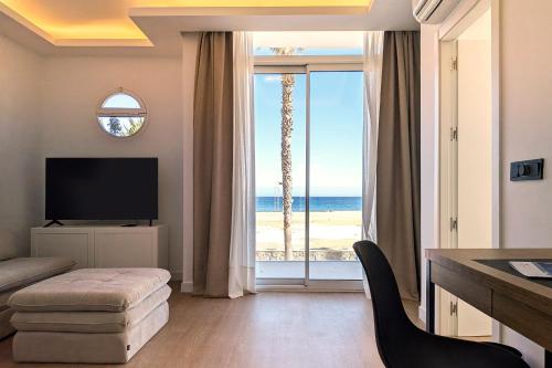 a living room with a view of the beach at Hotel Don Ignacio in San José