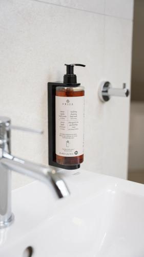 a bottle of soap sitting on top of a bathroom sink at Hotel Fatima in Trenčín