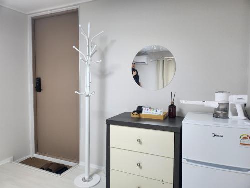 a kitchen with a white refrigerator and a mirror at Maison Veluna in Seoul