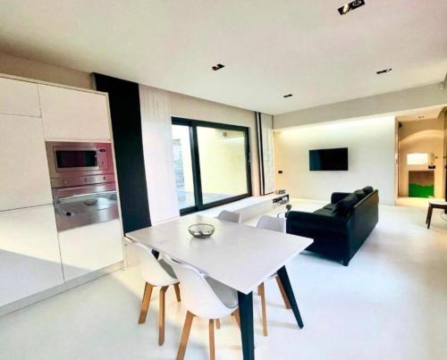 a kitchen and living room with a white table and chairs at Elegant Central Apartment Quiet and Bright in Brussels