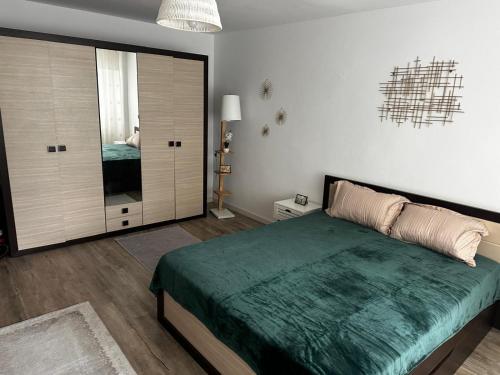 a bedroom with a bed and a large sliding glass door at Dragasani Cozy Apartament in Drăgăşani