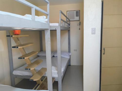 a bunk bed room with two bunk beds and a ladder at Elyu Seaside in San Juan