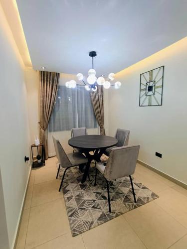 a dining room with a table and chairs at House 234 in Ungwan Bado