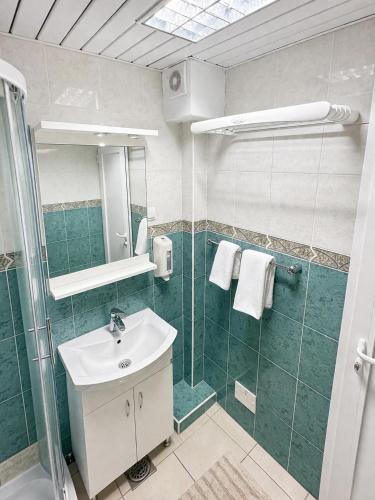 a bathroom with a sink and a shower at Sea View Apartment Rafailovići in Rafailovici