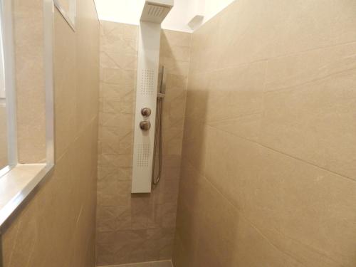 a bathroom with a shower with a glass door at Côte Landaise in Tarnos