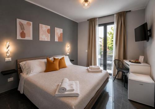 a bedroom with a bed with two towels on it at Reale Guest House in Mascalucia
