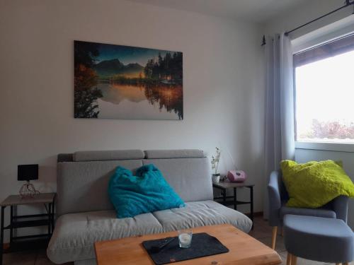 a living room with a couch and a table at Wellness Pension Hubertus in Marquartstein