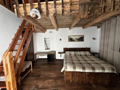 a bedroom with a bed and a wooden ceiling at B&B FANCHETTI 1938 in San Sebastiano