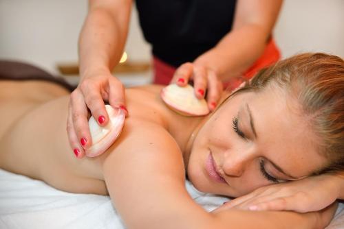 a woman laying on a bed getting a massage at Radisson BLU Balmoral in Spa