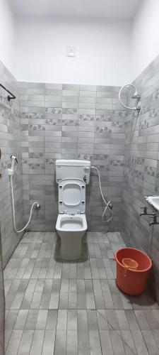 a bathroom with a toilet and a shower at Santha Residency in Ambātturai