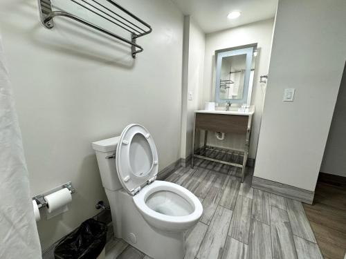 a white bathroom with a toilet and a sink at Lodge at Mill Creek Pigeon Forge in Pigeon Forge