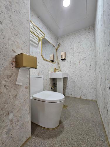 a bathroom with a white toilet and a sink at AnJin's Guest House in Mokpo