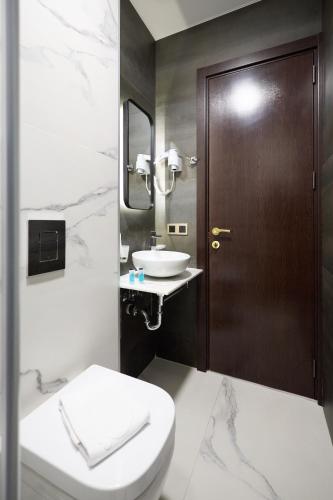 a bathroom with a toilet and a sink at Panorama Boutique Hotel in Tbilisi City