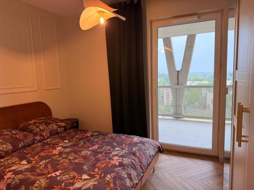 a bedroom with a bed next to a sliding glass door at COSMO Premium Park Chorzów, Parking, f-VAT klimatyzacja in Chorzów