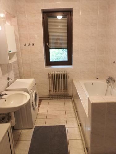 a bathroom with a sink and a tub and a toilet at Chalet Sedmihori in Staré Sedlo