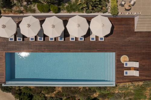 an overhead view of a swimming pool with umbrellas at Harmony Suites in Khelmáta