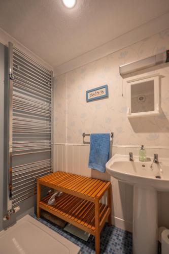 a bathroom with a sink and a toilet and a sink at Shop Cottage, Findhorn in Findhorn