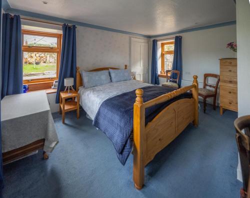 a bedroom with a large bed and a window at Shop Cottage, Findhorn in Findhorn